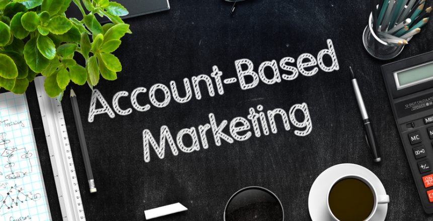 Account based marketing spelt out on a chalk board, next to a cup of coffee.